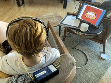 child with a neurofeedback at home system