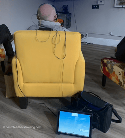 senior watching TV during a neurofeedback session using the neuroptimal braintraining system