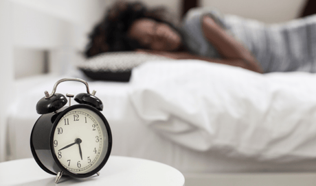 woman-sleeping-and-alarm-clock