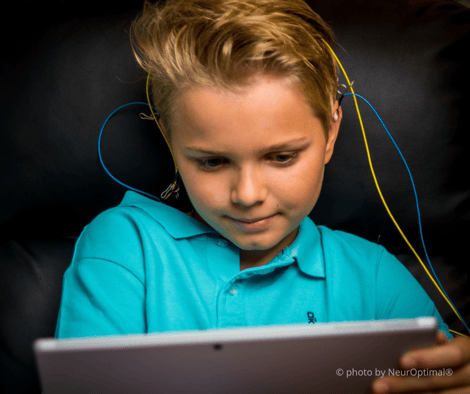 boy with eeg sensors using neuroptimal brain trainer