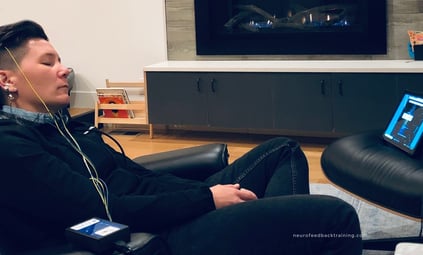 woman sleeping during a neuroptimal neurofeedback session at home