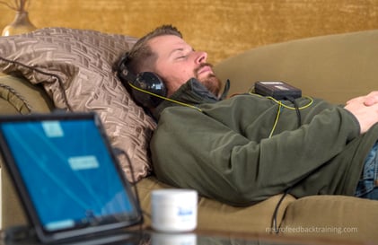 man relaxing during a Neuroptimal Neurofeedback home session