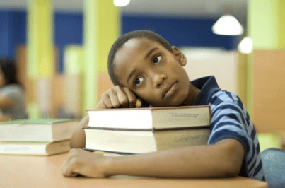 boy with books at school