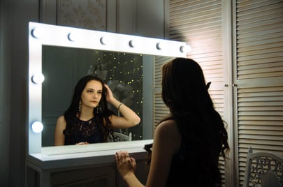 woman looking in mirror