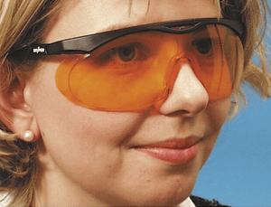 woman wearing orange glasses for night